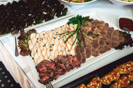 Fried seasoned juicy red meat on white plateの写真素材