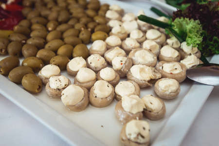 Stuffed champignon with cheese on white plate