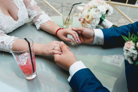Close-up couple holding hands during a wedding ceremonyの写真素材