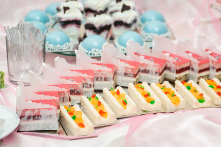 Set of different cakes sweets and desserts arranged on one plate. Party candy bar