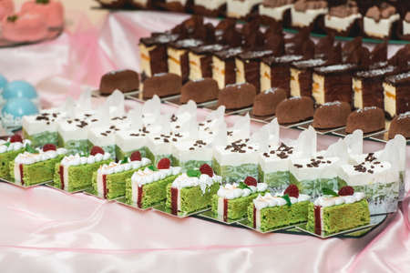 Cute candy bar with various pastry and cakes. Wedding sweetsの写真素材