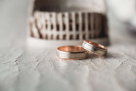 Pair of wedding golden rings on the cracked skinの写真素材