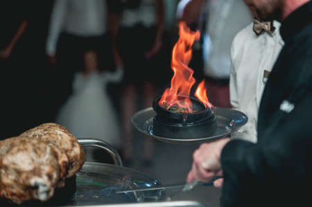 appetizing grilled meat on fire close-up. beautiful presentation of the dishes in the restaurantの写真素材