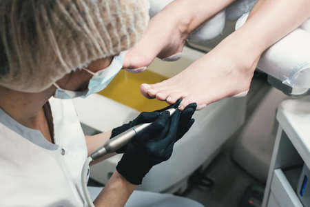 Professional hardware pedicure using electric machine.Patient on medical pedicure procedure,の写真素材