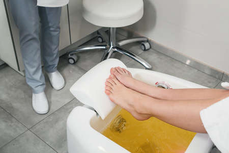 beautiful legs of a girl in a white bathrobe. modern beauty salonの写真素材