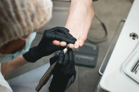 Professional hardware pedicure using electric machine.Patient on medical pedicure procedure,の写真素材
