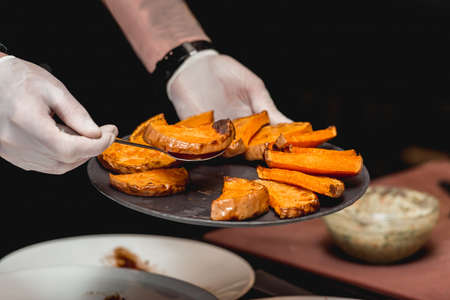 the chef makes a mexican dish. puts a sweet pumpkin on a plate. Mexican cuisine at the restaurant