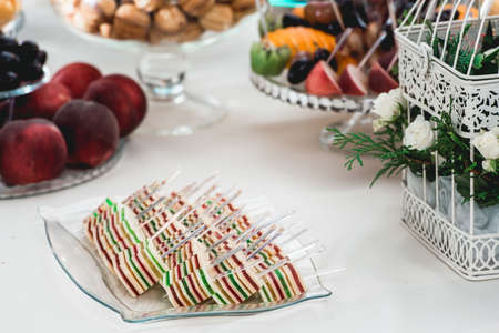 glass stand with cupcakes on a wedding candy bar tableの写真素材