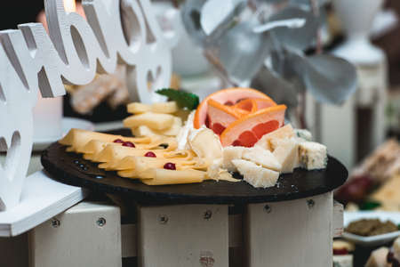 Candybar in a restaurant. Decorated white table fool of sweet pastryの写真素材