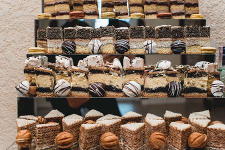 Candybar in a restaurant. Decorated white table fool of sweet pastryの写真素材