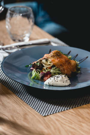 delicious salmon salad with egg in a restaurant. small portionの写真素材