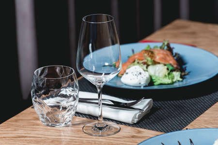 delicious salmon salad with egg in a restaurant. small portionの写真素材