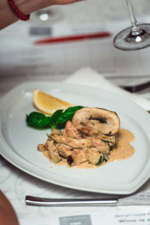 portion of delicious fish fillet in sauce at the restaurant. small portionの写真素材