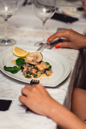 portion of delicious fish fillet in sauce at the restaurant. small portionの写真素材