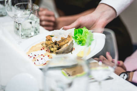 portion of delicious fish fillet in sauce at the restaurant. small portionの写真素材