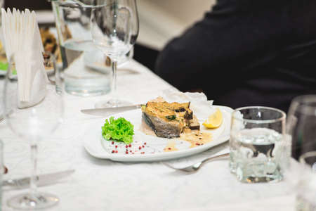 portion of delicious fish fillet in sauce at the restaurant. small portionの写真素材