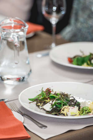 Salad with brie cheese, dandelions and strawberries.の写真素材