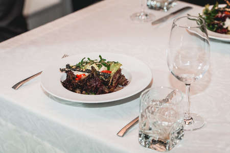 woman holds glass of red wine. people consider the color of the wine and try how it smells in different glassesの写真素材