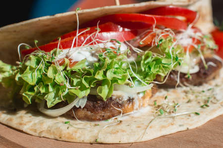 great mexican taco with meat schnitzel with cheese and vegetablesの写真素材