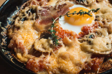 tortilla con potatos. Typical spanish dish with bacon cheese tomato sauce and eggの写真素材