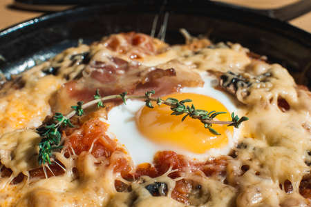 tortilla con potatos. Typical spanish dish with bacon cheese tomato sauce and eggの写真素材