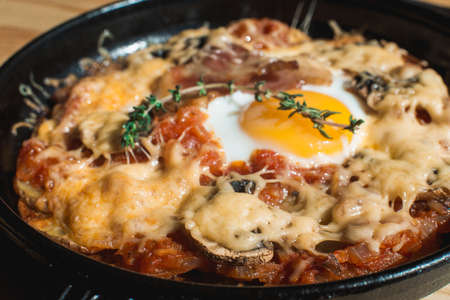 tortilla con potatos. Typical spanish dish with bacon cheese tomato sauce and eggの写真素材