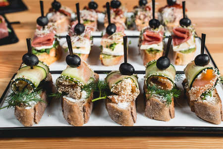 tasty pinchos with tuna, chorizos, salmon, egg, dried tomatoes, avocado, salmon, bacon, Hamon, Brie...