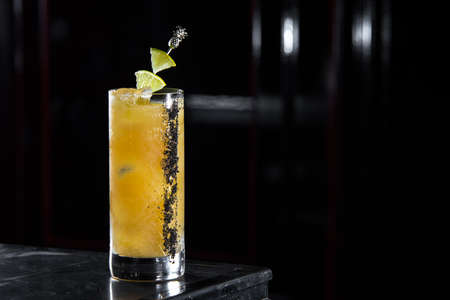 el sol cocktail on a bar desk. black backgroundの写真素材