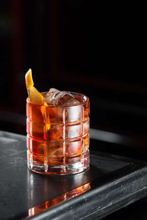 Boulevardie cocktail on a bar desk. black backgroundの写真素材