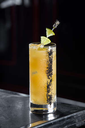 el sol cocktail on a bar desk. black backgroundの写真素材