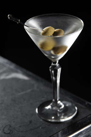 Dry Martini cocktail on a bar desk. black backgroundの写真素材