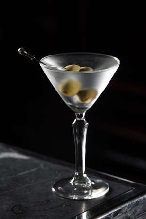 Dry Martini cocktail on a bar desk. black backgroundの写真素材