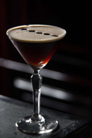 Espresso Martini cocktail on a bar desk. black background.の写真素材
