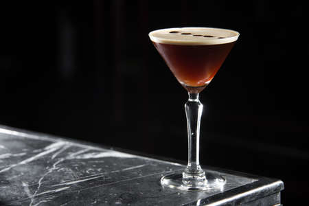 Espresso Martini cocktail on a bar desk. black background.の写真素材