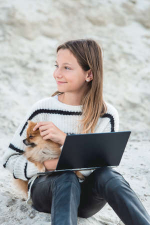 11 years girl with tablet pc. against a sand hill. close upの写真素材