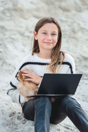 11 years girl with tablet pc. against a sand hill. close upの写真素材