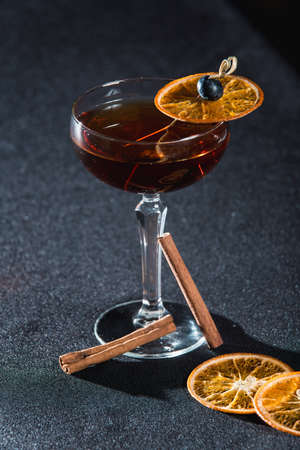 The Boulevardier Cocktail with orange chips on top. On a bar deskの写真素材