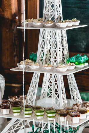 green style wedding candy bar on a white table. cupcakes decorated with a green ribbon bow