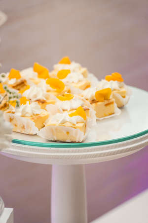 white stand with cupcakes on a candy bar tableの写真素材