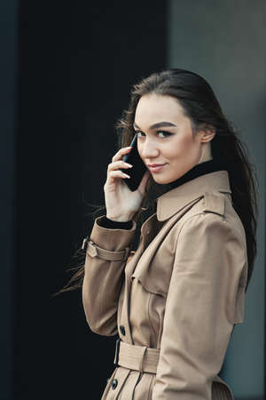 Self-confidence young business woman with file in a hand. outdoor. cityscapeの写真素材