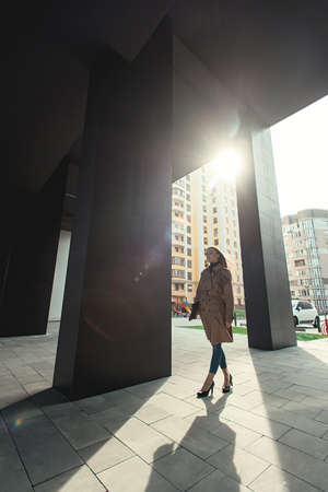 Self-confidence young business woman with file in a hand. outdoor. cityscapeの写真素材
