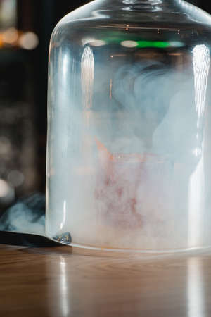 Boulevardie cocktail on a bar desk. Bright background. Smoking cocktailの写真素材