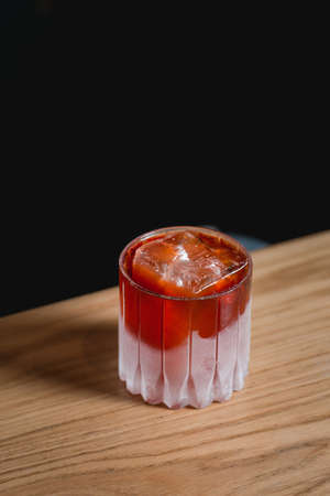 Boulevardie cocktail on a bar desk. Black background.の写真素材