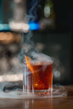 Boulevardie cocktail on a bar desk. Bright background. Smoking cocktailの写真素材