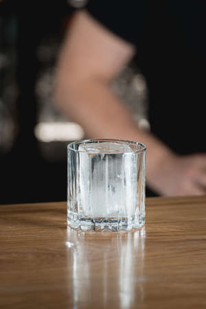 Big piece of ice in a cocktail glass on a black background.の写真素材