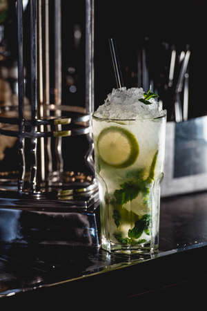 glass of cold mojito on a table in the barの写真素材
