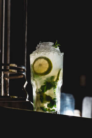 glass of cold mojito on a table in the barの写真素材