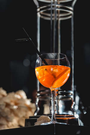 glass of refreshing orange alcoholic cocktail on a table in the bar.の写真素材