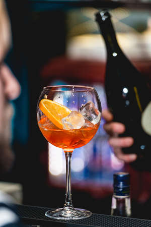 glass of refreshing orange alcoholic cocktail on a table in the bar.の写真素材