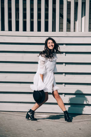 lifestyle portrait of young stylish hipster woman, wearing trendy white dressの写真素材
